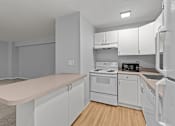 Thumbnail 46 of 51 - A kitchen with white appliances and cabinets.