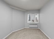 Thumbnail 43 of 51 - A room with a window and a radiator on the floor.