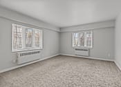 Thumbnail 36 of 51 - A room with a carpeted floor and two windows.