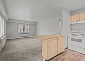Thumbnail 33 of 51 - A kitchen with a white stove and a window with blinds.