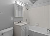 Thumbnail 37 of 51 - A white bathroom with a sink, mirror, and bathtub.