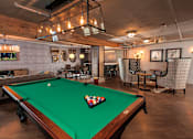 Thumbnail 5 of 51 - A pool table with a green felt cloth and a white cue ball in the middle.