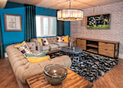Thumbnail 8 of 51 - A living room with a grey sofa and a wooden coffee table.
