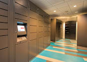 Thumbnail 4 of 51 - A hallway with a row of ATMs on the wall.