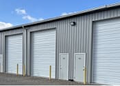 Thumbnail 10 of 13 - A row of metal garage doors are closed.