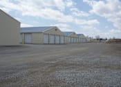 Thumbnail 3 of 10 - A row of garages are lined up in a field.