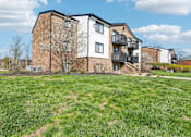 Thumbnail 29 of 30 - A large grassy area in front of a multi-story building at Grand Valley Apartments, OH, 46150