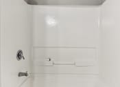 Thumbnail 7 of 33 - A white bathroom with a toilet and a shower.