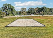 Thumbnail 1 of 33 - A large sand pit in the middle of a grassy field.