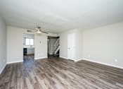 Thumbnail 29 of 31 - A room with wooden floors and white walls.