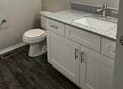 Thumbnail 9 of 31 - Bathroom with granite counter tops and a large mirror at Black Hawk Apartments, Fort Wayne, Indiana