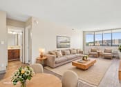 Thumbnail 8 of 22 - Virtually staged Irvine Park Towers apartment living and dining room with neutral furnishings
