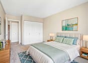 Thumbnail 16 of 22 - Virtually staged Irvine Park Towers bedroom with bed, nightstands and double closet doors