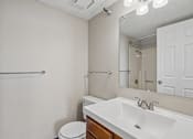 Thumbnail 21 of 22 - Irvine Park Towers apartment bathroom with vanity, mirror, toilet and tub-shower combination