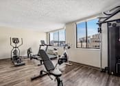 Thumbnail 6 of 22 - Fitness center with cardio and strength equipment at Irvine Park Towers