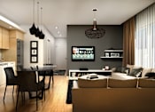 Thumbnail 3 of 7 - A modern living room with a kitchen area in the background.