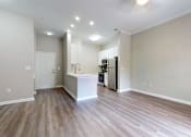 Thumbnail 13 of 23 - A kitchen area with a white countertop and wooden flooring. at Vue at Embry Hills, Atlanta, GA, 30042
