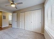 Thumbnail 9 of 20 - A room with a ceiling fan and carpeted floor at Spalding Vue, Peachtree Corners, GA.