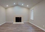Thumbnail 12 of 20 - A room with a fireplace and wood flooring. at Spalding Vue, Peachtree Corners, 30092