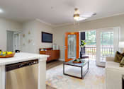 Thumbnail 9 of 23 - A modern kitchen with a stainless steel dishwasher and a glass coffee table at Embry Hills, Atlanta, 30042