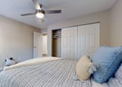 Thumbnail 9 of 26 - A bedroom with a bed, pillows, and a ceiling fan.