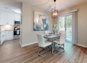 Thumbnail 4 of 26 - A dining room with a table and chairs.