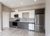 Thumbnail 72 of 72 - A modern kitchen with stainless steel appliances and wooden cabinets.