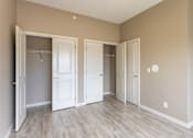 Thumbnail 53 of 72 - Three white doors are in a room with wood floors and beige walls.