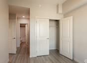 Thumbnail 70 of 72 - A white door is open to a hallway.