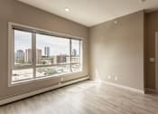 Thumbnail 71 of 72 - A room with a large window overlooking a cityscape.