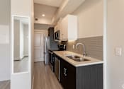 Thumbnail 54 of 72 - A modern kitchen with dark wood cabinets and a white countertop.