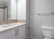 Thumbnail 59 of 72 - A white toilet sits in a bathroom next to a sink.