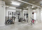 Thumbnail 57 of 72 - A bike rack with several bicycles parked in a concrete garage.
