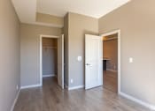 Thumbnail 52 of 72 - A room with a white door and a brown door.