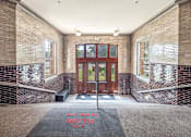 Thumbnail 26 of 29 - A brick building with a red mat that says "Easton High School" on it.