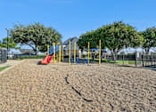 Thumbnail 17 of 17 - A playground with a yellow swing set and a red slide.