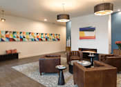 Thumbnail 8 of 43 - A living room with a fireplace and a painting on the wall. at Ravello Apartments, Redmond, WA