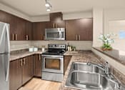 Thumbnail 12 of 18 - A modern kitchen with a stainless steel refrigerator, oven, and sink.