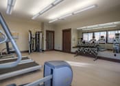 Thumbnail 6 of 18 - A gym with treadmills, weights, and exercise equipment. at Mill Creek Meadows Apartments, Mill Creek, Washington
