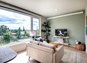 Thumbnail 4 of 22 - Living Area With TV at Metro Line Flats, Seattle, WA, 98122