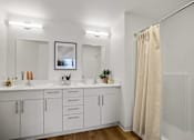 Thumbnail 5 of 43 - A bathroom with a white cabinet and a shower curtain. at Riverfront Everett, Washington, 98201