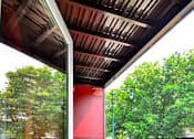 Thumbnail 30 of 43 - A red wall with a chair in front of it. at Ravello Apartments, Redmond, WA