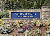 Thumbnail 9 of 19 - A sign that says Valley Springs Apartment Homes in front of a garden. at Valley Springs Apartments, Renton, WA