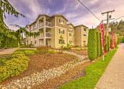 Thumbnail 6 of 19 - A residential building with a well-maintained garden in front. at Valley Springs Apartments, Renton 98058
