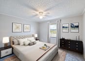 Thumbnail 5 of 6 - A bedroom with a large bed, a dresser, and a ceiling fan.