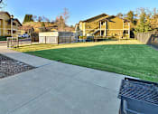 Thumbnail 12 of 41 - A residential area with houses and a green lawn.