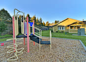 Thumbnail 8 of 41 - A playground with a slide and monkey bars.