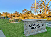 Thumbnail 3 of 41 - A stone sign that says Kennedy Meadows stands in a grassy area.