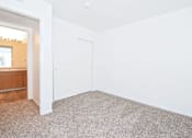 Thumbnail 21 of 30 - A white room with a carpeted floor and a white door.