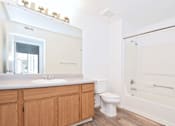 Thumbnail 25 of 30 - A bathroom with a toilet, sink, and bathtub.